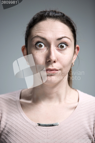 Image of Portrait of young woman with shocked facial expression