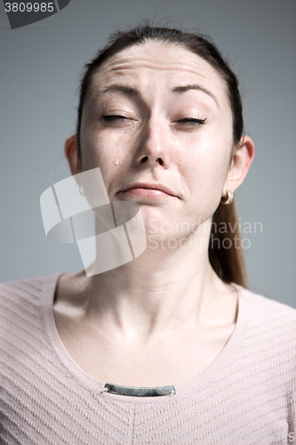 Image of The crying woman with tears on face closeup