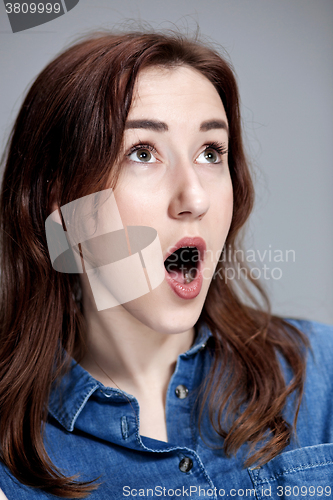 Image of Portrait of young woman with shocked facial expression