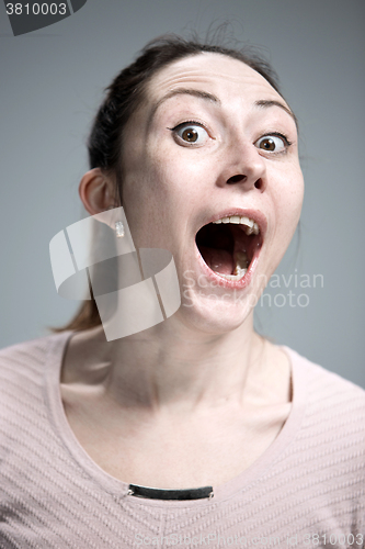 Image of Portrait of young woman with shocked facial expression