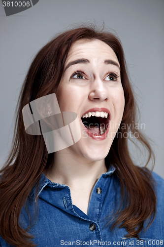 Image of Portrait of young woman with shocked facial expression