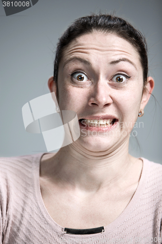 Image of Portrait of young woman with shocked facial expression