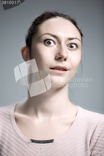 Image of Portrait of young woman with shocked facial expression