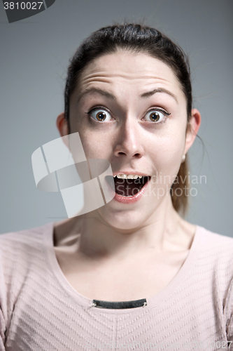 Image of Portrait of young woman with shocked facial expression