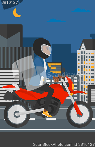 Image of Woman riding motorcycle.