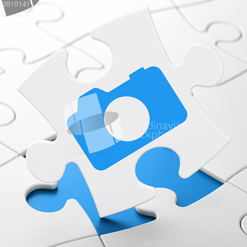 Image of Travel concept: Photo Camera on puzzle background
