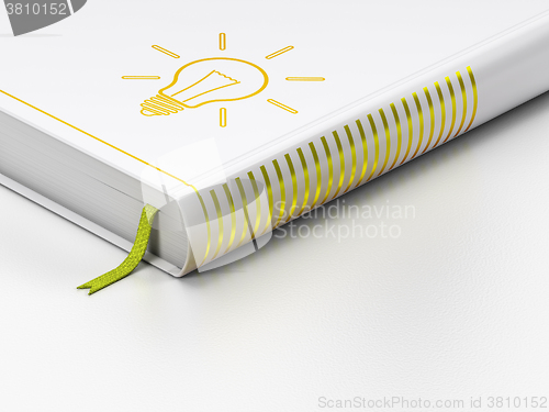 Image of Finance concept: closed book, Light Bulb on white background