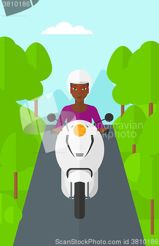 Image of Woman riding scooter.