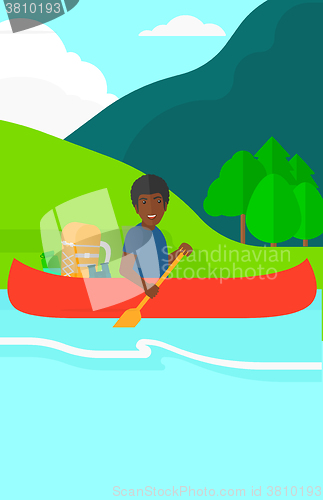 Image of Man canoeing on the river.