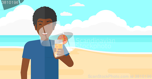 Image of Tourist with cocktail on the beach.