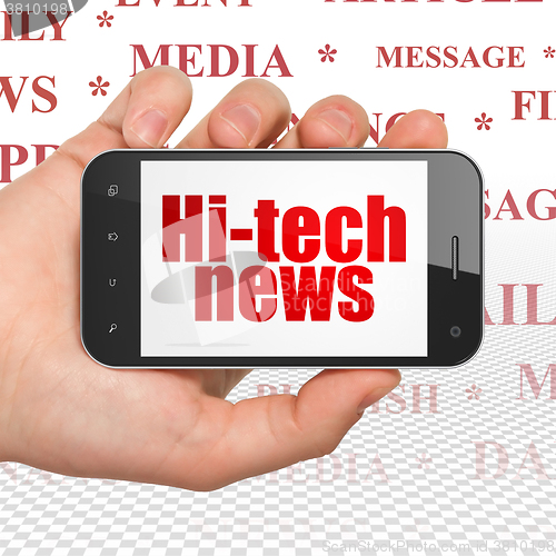 Image of News concept: Hand Holding Smartphone with Hi-tech News on display