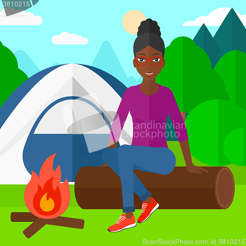 Image of Woman sitting at camp.