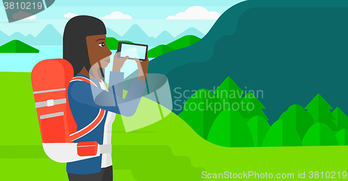 Image of Backpacker taking photo.