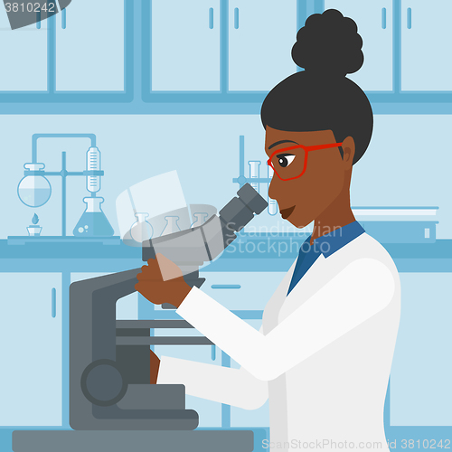 Image of Laboratory assistant with microscope.