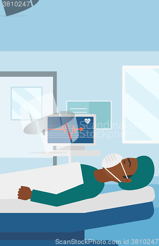 Image of Patient lying in hospital bed with heart monitor.
