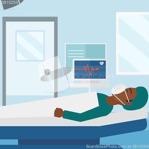 Image of Patient lying in hospital  bed with heart monitor.