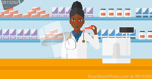 Image of Pharmacist showing some medicine.