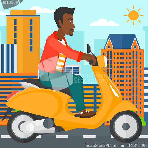 Image of Man riding scooter.