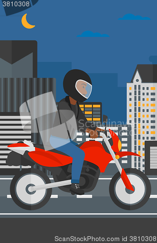 Image of Man riding motorcycle.