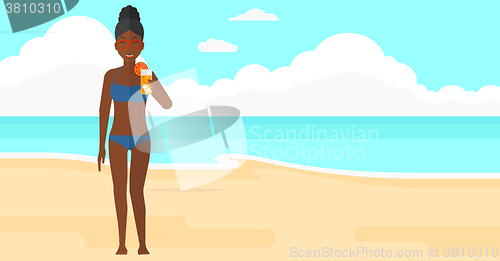 Image of Tourist with cocktail on the beach.