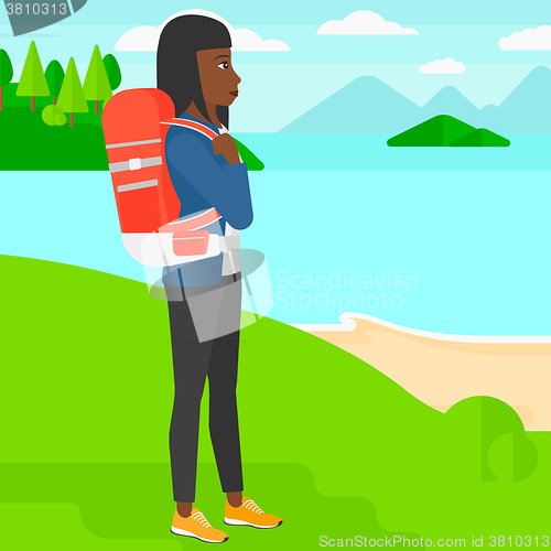 Image of Woman with backpack hiking.