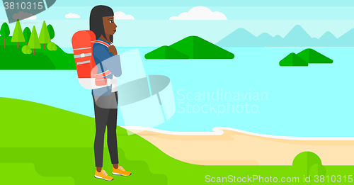 Image of Woman with backpack hiking.