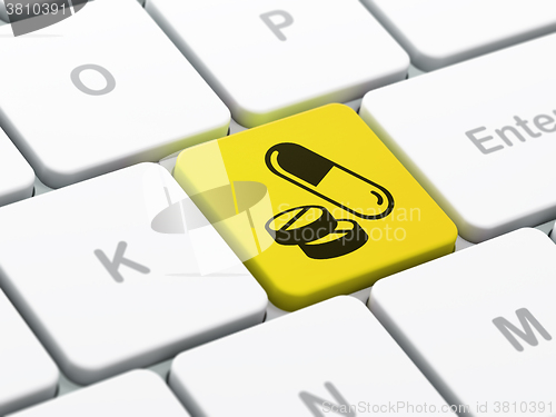 Image of Health concept: Pills on computer keyboard background
