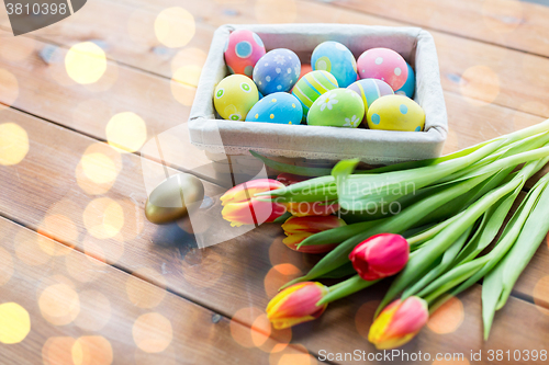 Image of close up of colored easter eggs and flowers