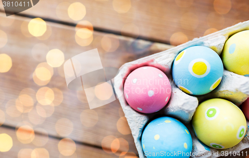 Image of close up of colored easter eggs in egg box