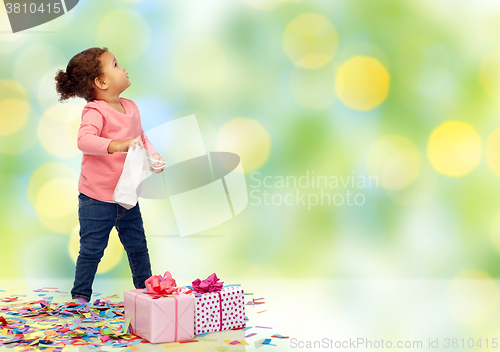 Image of happy little baby girl with birthday presents