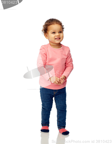 Image of smiling beautiful little baby girl walking