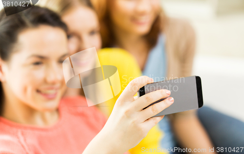 Image of close up of friends taking selfie with smartphone