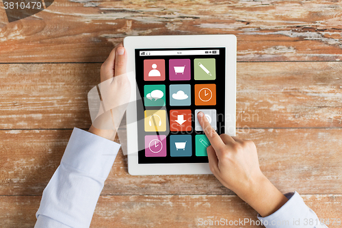 Image of close up of hands with applications on tablet pc