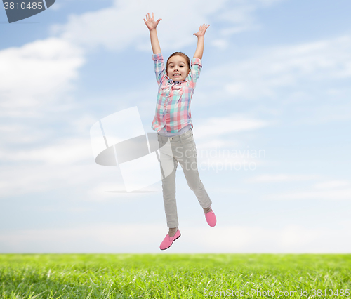 Image of happy little girl jumping in air