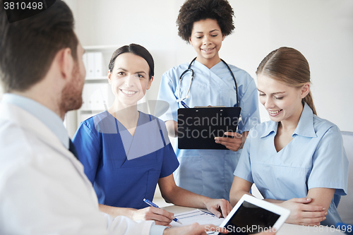 Image of group of happy doctors meeting at hospital office