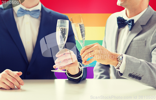 Image of close up of male gay couple with champagne glasses