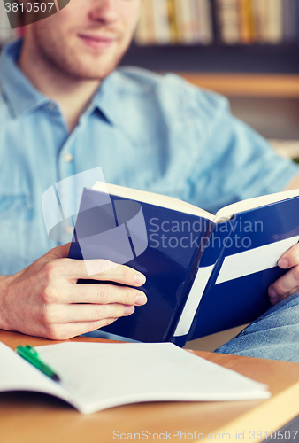 Image of close up of student reading book at school