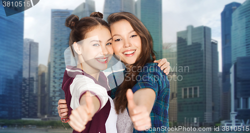 Image of happy smiling teenage girls showing thumbs up