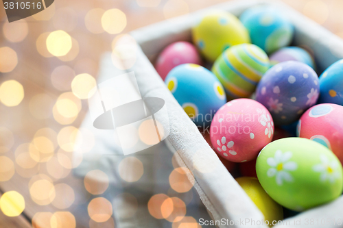Image of close up of colored easter eggs in basket