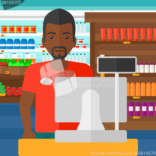 Image of Salesman standing  at checkout.