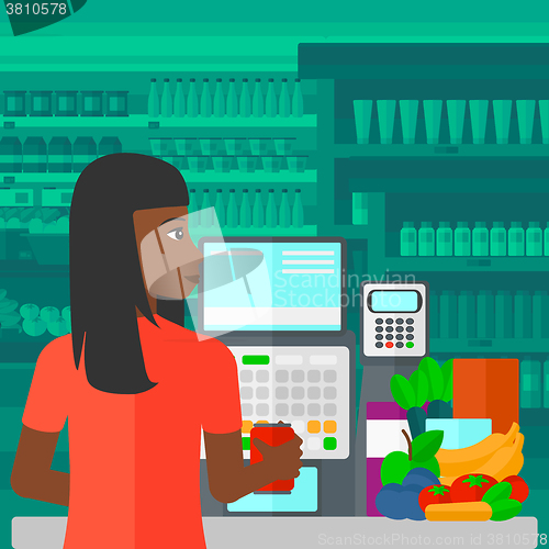 Image of Cashier at supermarket checkout.