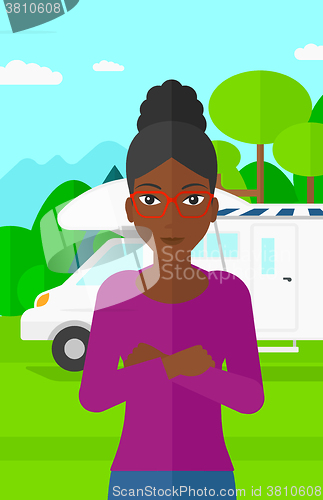 Image of Woman standing in front of motor home.