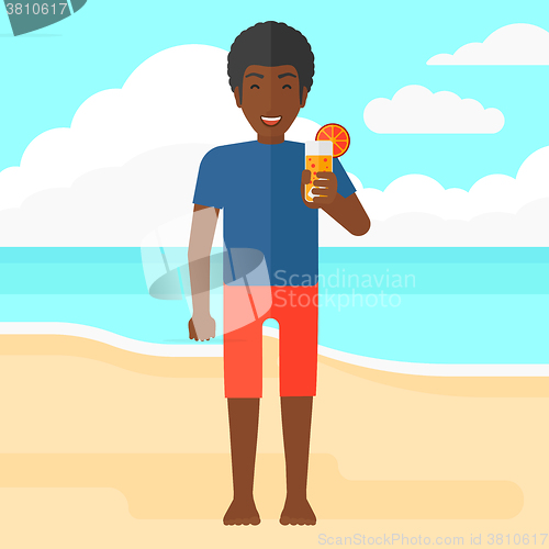 Image of Tourist with cocktail on the beach.