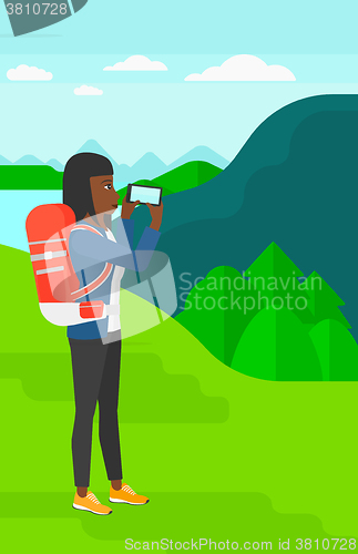 Image of Backpacker taking photo.