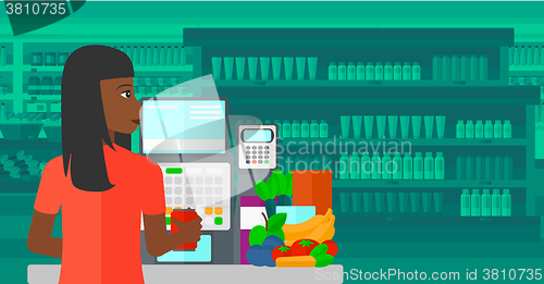 Image of Cashier at supermarket checkout.