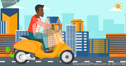 Image of Man riding scooter.