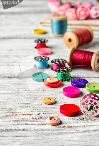 Image of Buttons and spool of thread