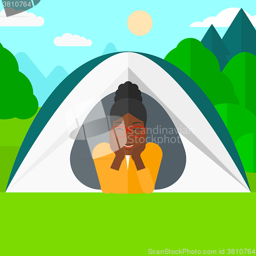Image of Woman lying in tent.