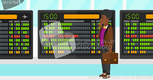 Image of Man looking at schedule board.