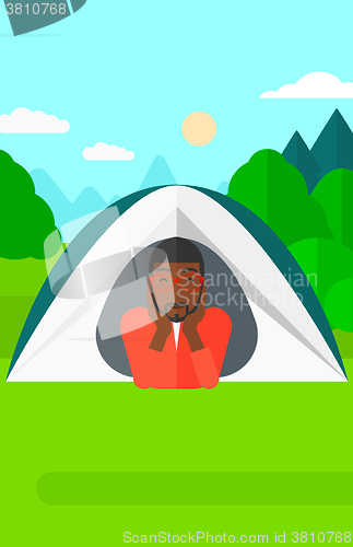 Image of Man lying in tent.